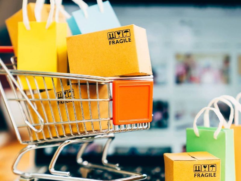 Small shopping cart filled with colorful bags and boxes